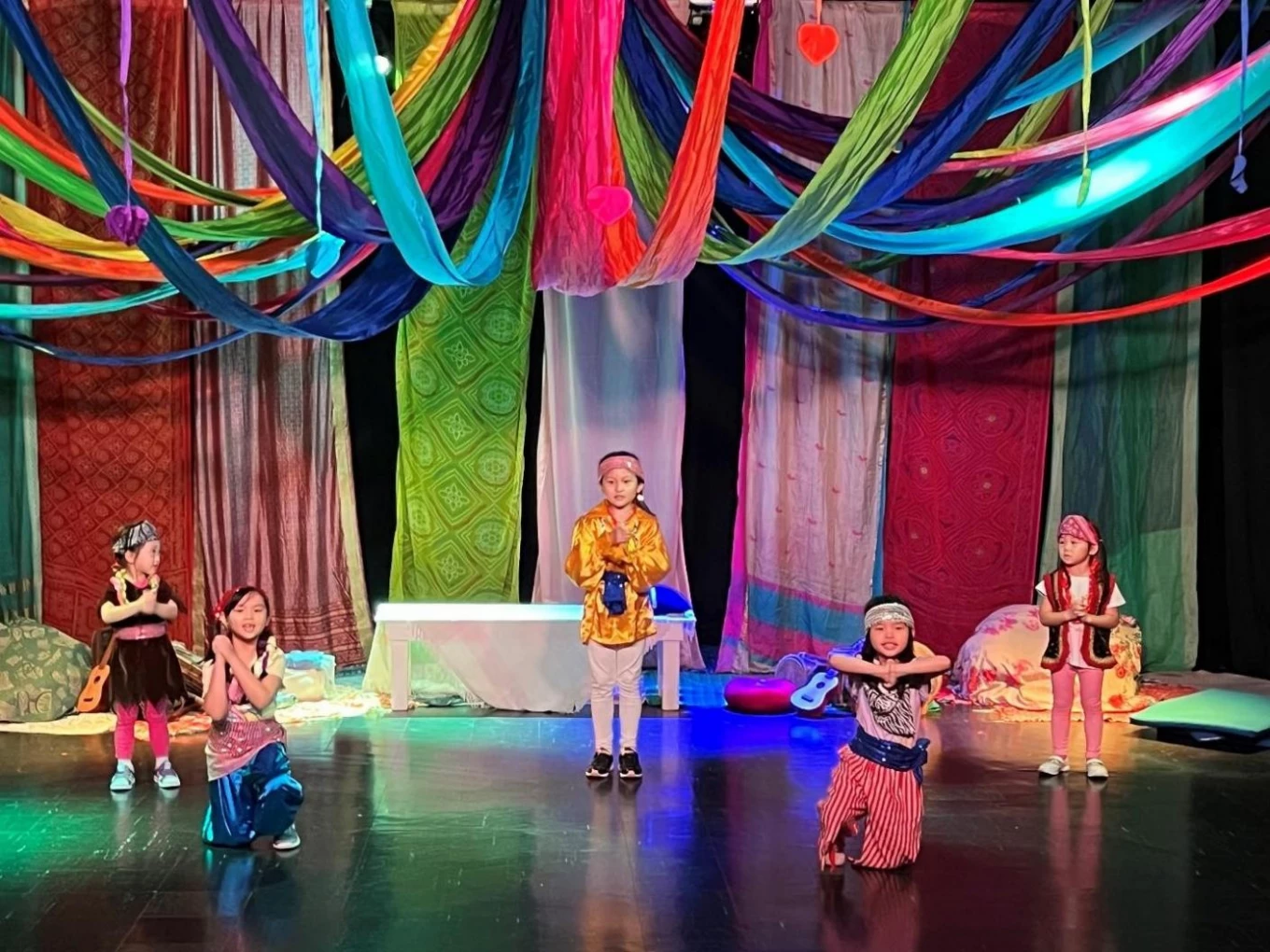 A group of children on a stage Description automatically generated