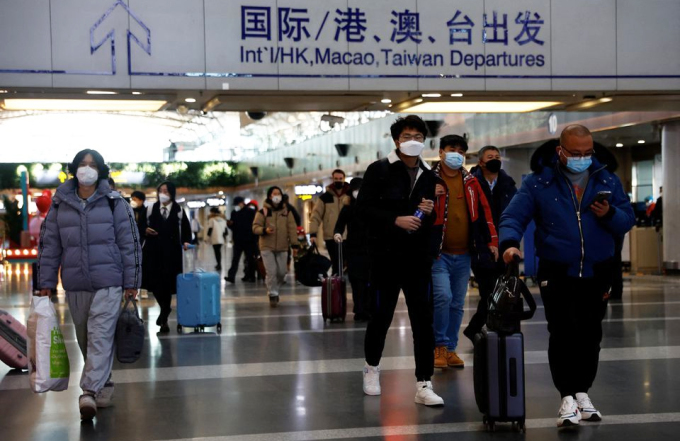 Hành khách đi máy bay tại sân bay quốc tế thủ đô Bắc Kinh ngày 27/12. Ảnh: Reuters
